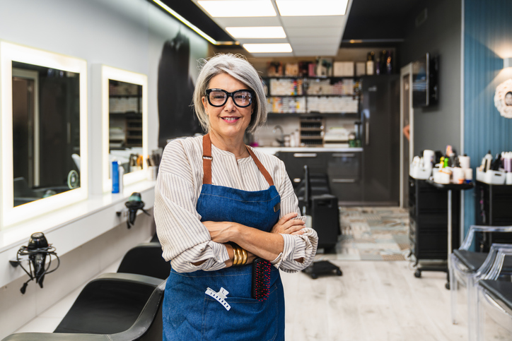 Salon owner standing in her salon