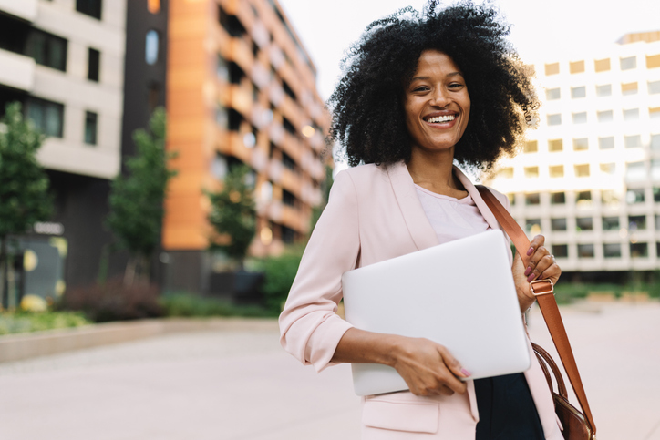 Professional woman holding a laptop