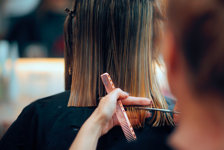 Stylist cutting wet hair