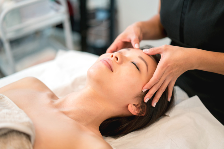 Client receiving a facial massage at a spa