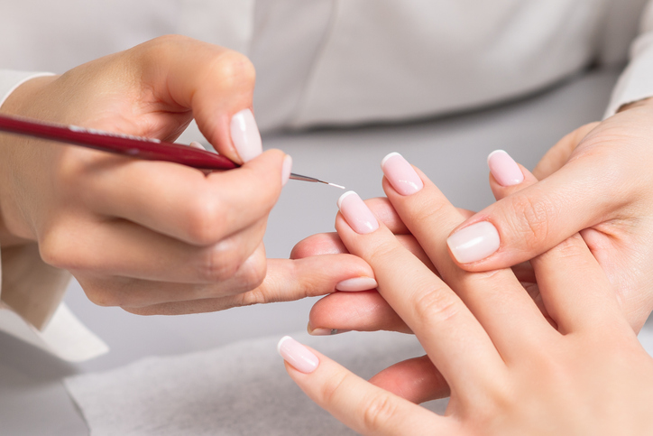 Client receiving a French manicure
