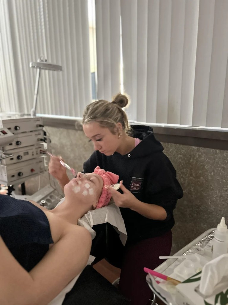 BCSBC esthetics student giving a facial