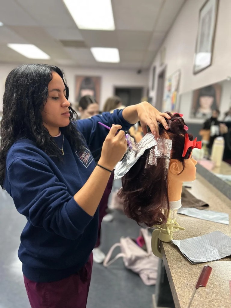 BCSBC cosmetology student styling hair