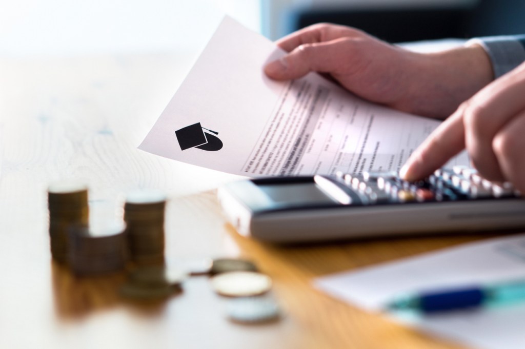 Student planning tuition costs with a calculator